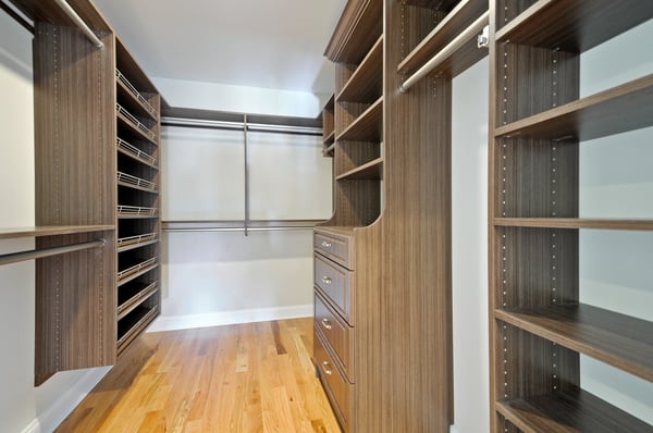 Milk Chocolate Walk In Closet with Satin Nickel Hardware, Decorative Shoe Shelves, and Raised Panel Hutch Drawers