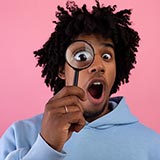 Man holding magnifying glass up