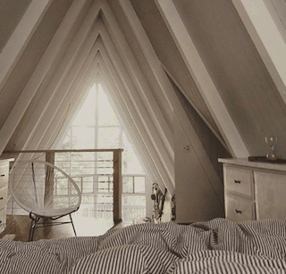 Apartment Therapy Instagram account showing bedroom in A-frame apartment