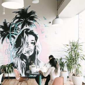 Creative WeWork office space with mural and palm trees