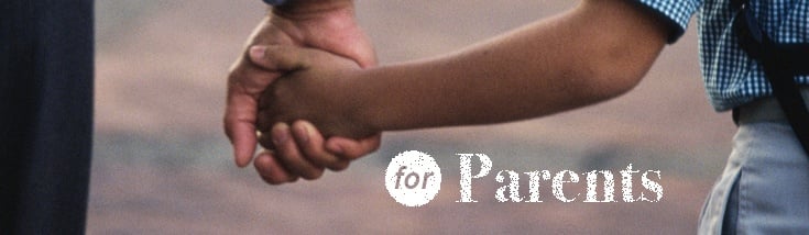 Parent holds hands with a child. Link goes to USAGov's health page. 