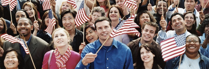 Diverse group of people waving American flags
