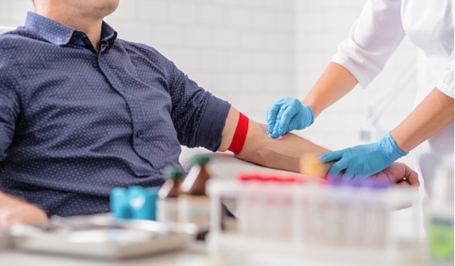 Doctor prepares man to donate blood