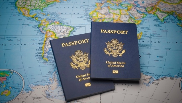 Two passports atop a world map