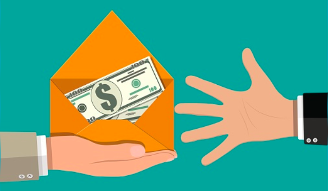Presenting an envelope of cash to an open hand