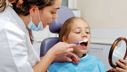 Child at the dentist. Link takes you to Medplus page on children's dental health month.