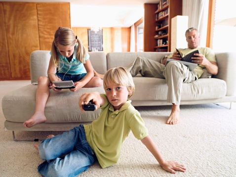 Children watches television. Link goes to KidsHealth's page on talking about the news.