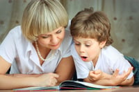 A mother and child read together. Link goes to CDC's Amazing Books for children.