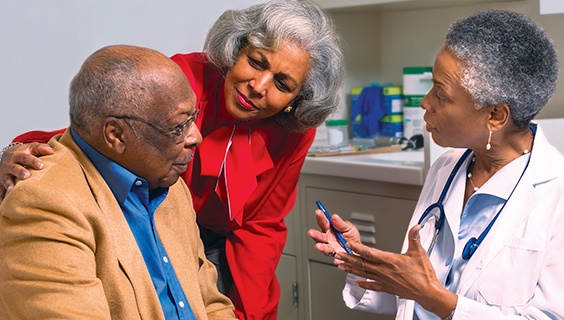 Older couple discusses with a doctor in her office