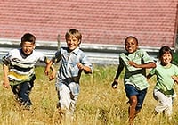Children run in a field. Link goes to HealthFinder's page on being active.