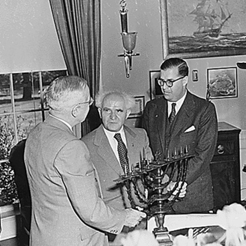 President Truman is presented with a menorah in the Oval Office by Israeli Prime Minister David Ben-Gurlon