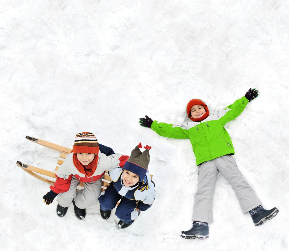 Happy kids with sledding on snow ground.jpeg