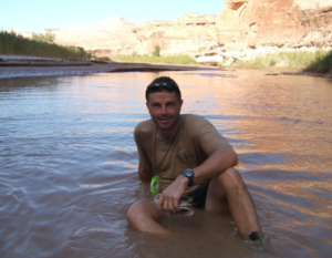 Reid bathes in the Dirty Devil River on a 2010 NOLS expedition in Utah