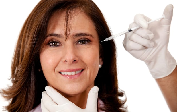 Woman getting a face lift with Botox - isolated over a white background-1