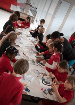 Students work together on a collage