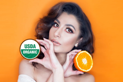 Assuaged-beautiful-woman-anti-aging-holding-orange-representing-healthy-living-1