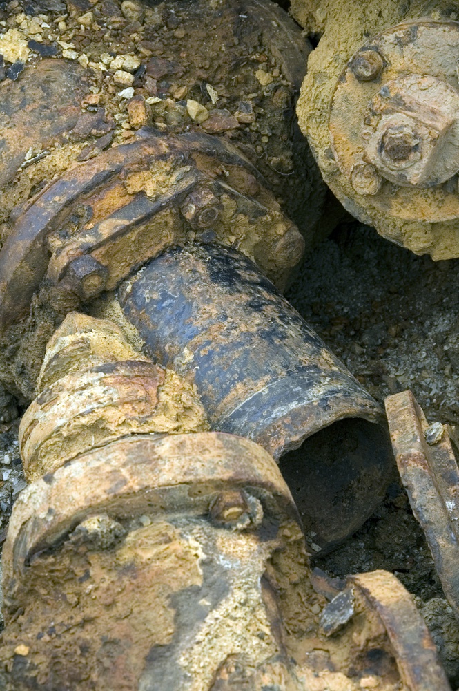 Encrusted old pipes in a dump - grunge close-up