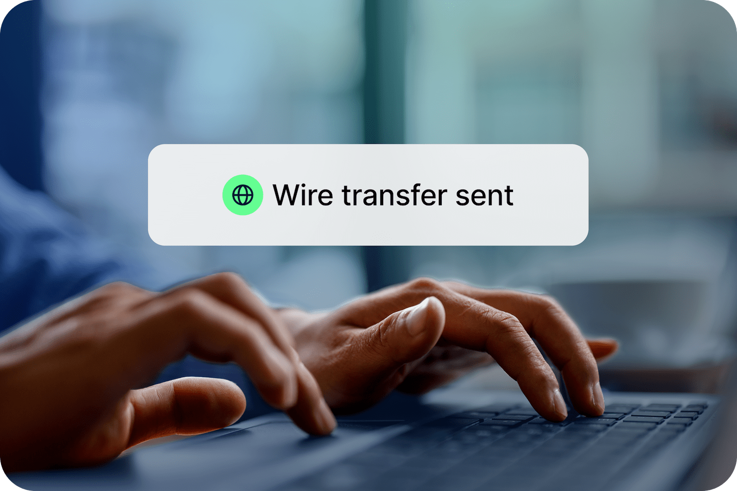 Someone sends a wire transfer on a laptop