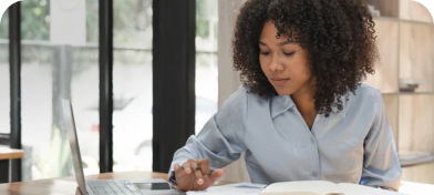 A woman reviews documents on her desk