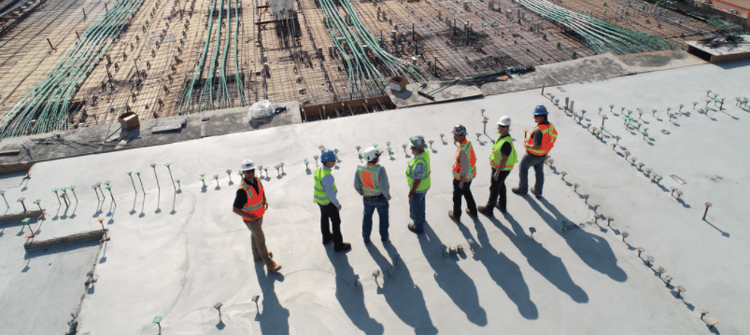 Group of construction workers having a discussion on a construction site. 