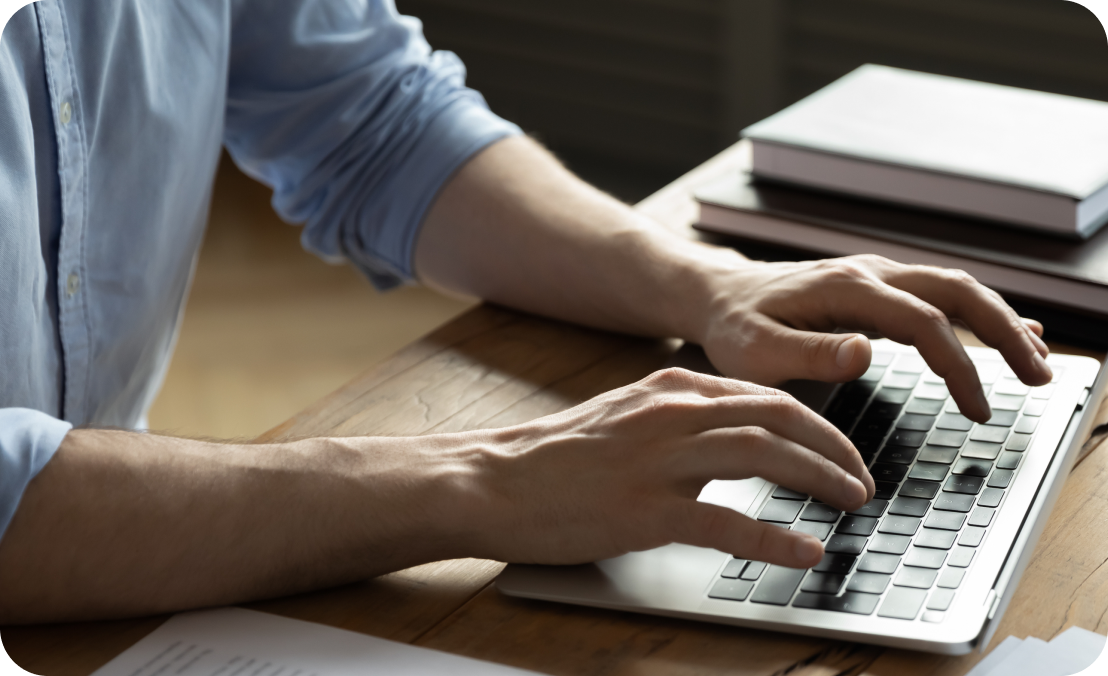 Close-up of a man entering invoice data into AP automation software to simplify his accounts payable process.