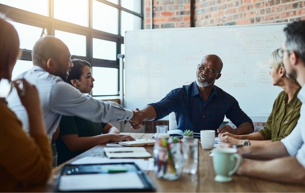 People shaking hands during a a meeting