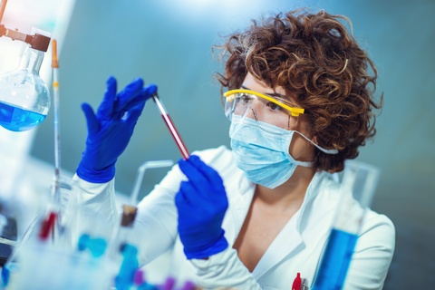 woman in lab doing tests on blood