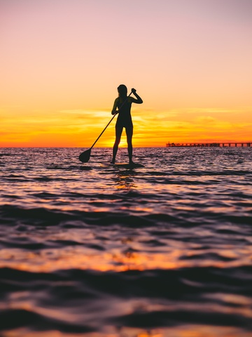 paddle boarding at dusk