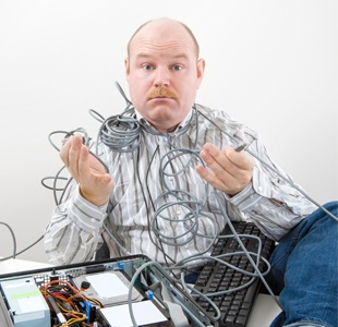 photodune-18523863-confused-businessman-holding-tangled-cables-of-computer-at-desk-l-resized.jpg