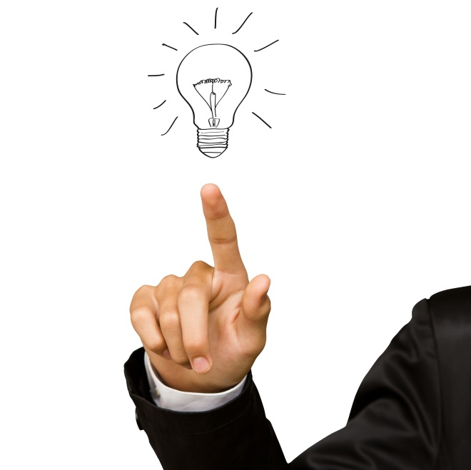 Business hand pointing at an idea light bulb to signify the items you need to know before setting up a successful work-from-home environment