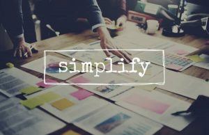 Cluttered business desk with the word simplify | Varay, El Paso