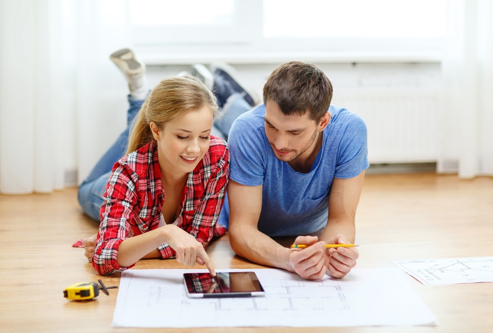 couple looks at tablet to remodel or design home