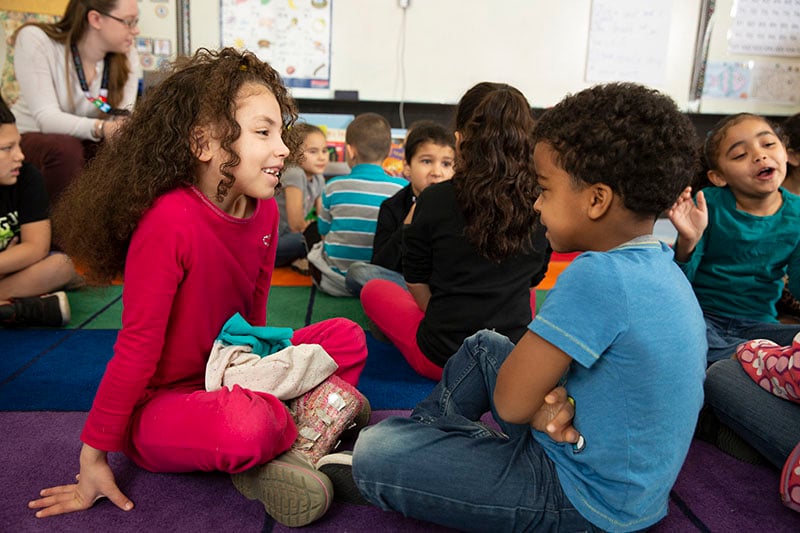children talking in classroom