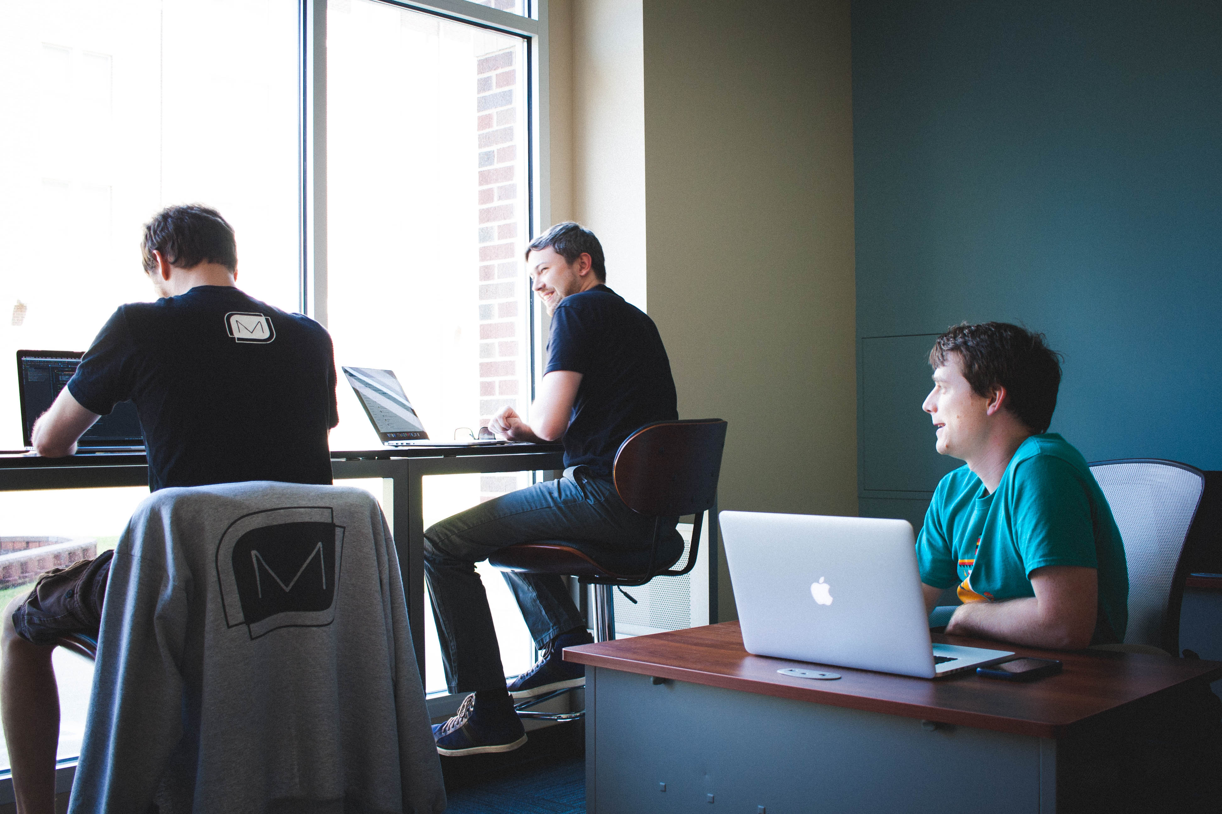 mobile app developers chatting in the UCA office