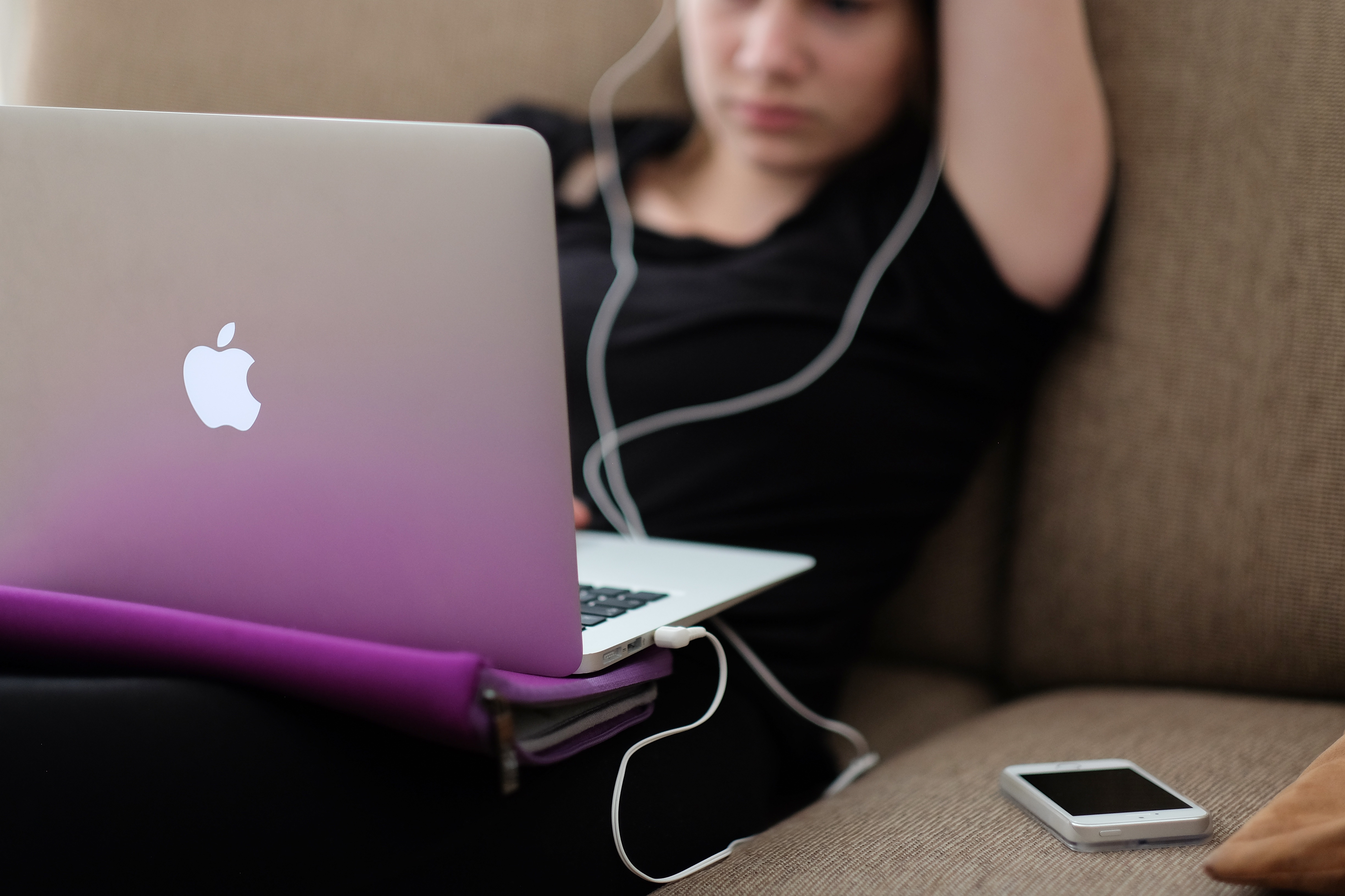 girl working remotely with computer on couch