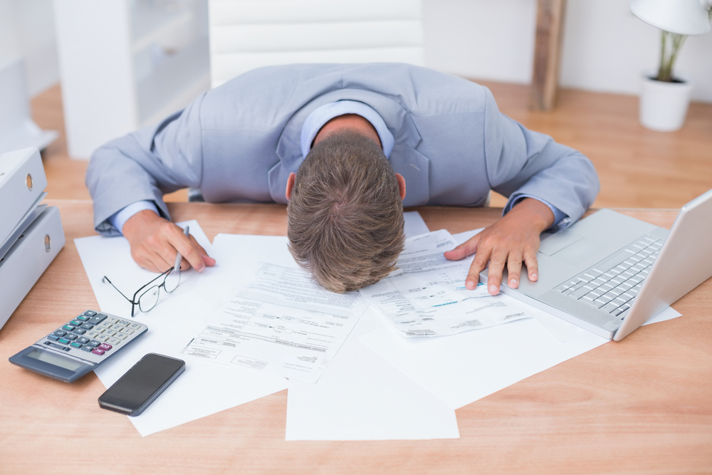 Businessman being depressed by accounting in his office-1