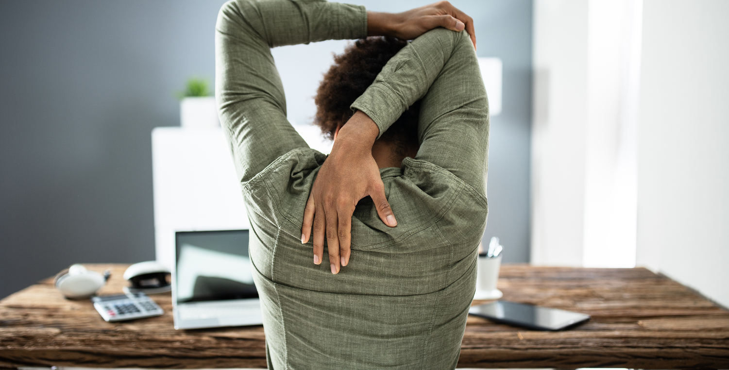 person stretching at desk