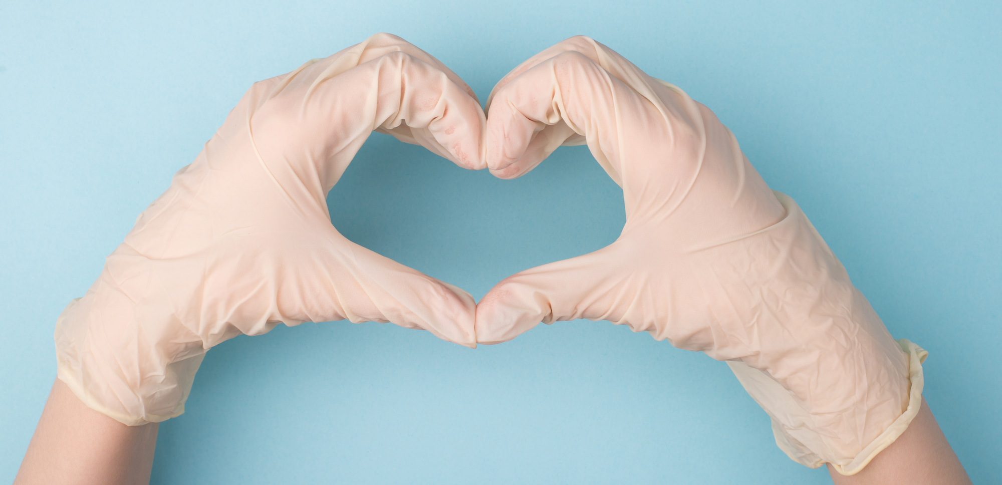 gloved hands forming heart