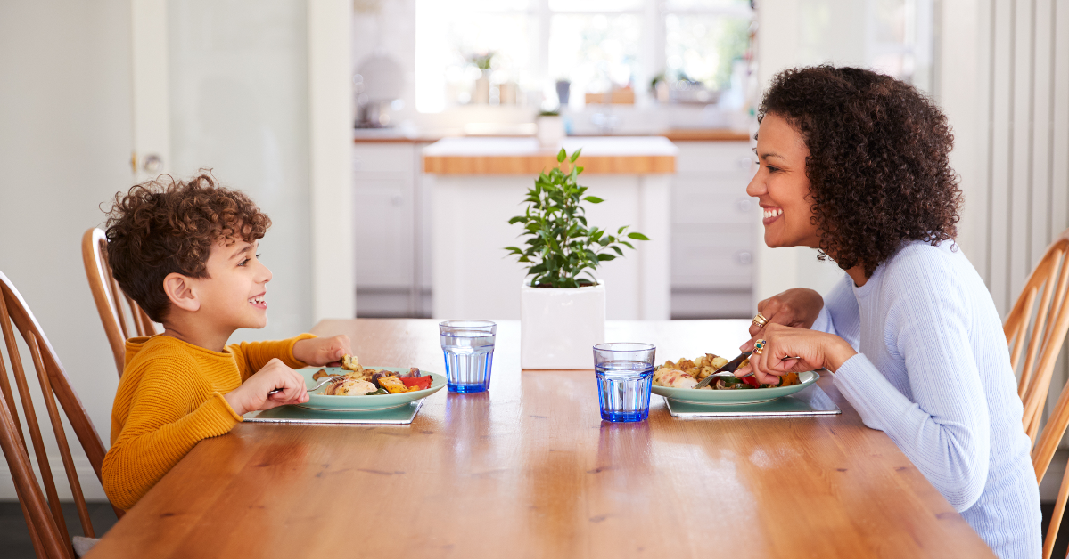mother and son eating dinner together at kitchen table
