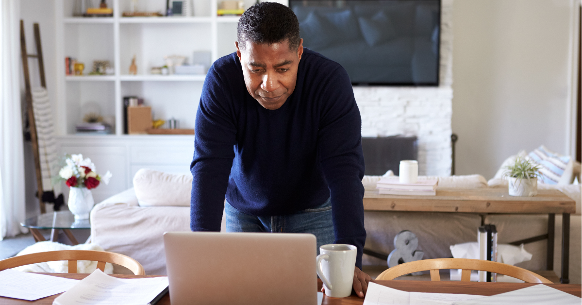 man working at home from dining table