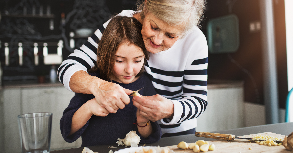 Grandmother teaching granddaughter to cook