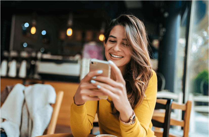 Young Woman on Smartphone in Cafe