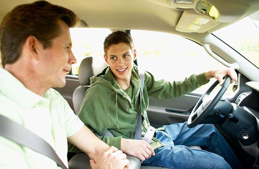 dad teaching son to drive