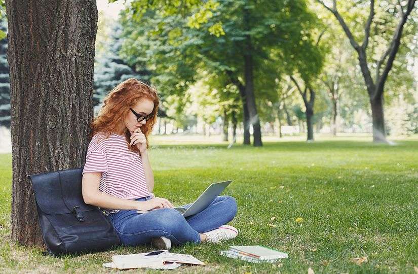 Student Studying Outdoors Under Tree