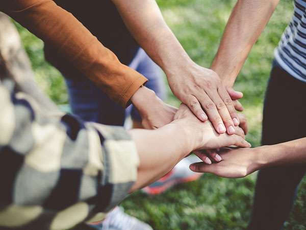 group joining hands