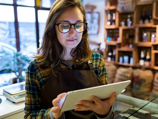 retailer on tablet wearing flannel