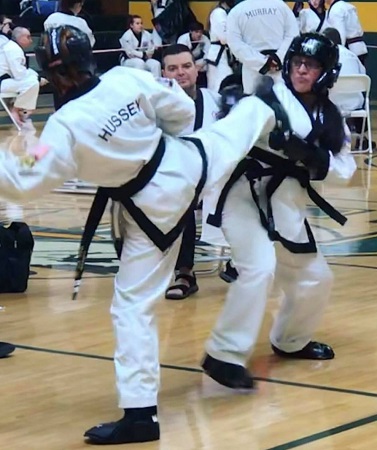 Hussey sparring in a tournament. Century Student Headgear, Gloves and Boots.