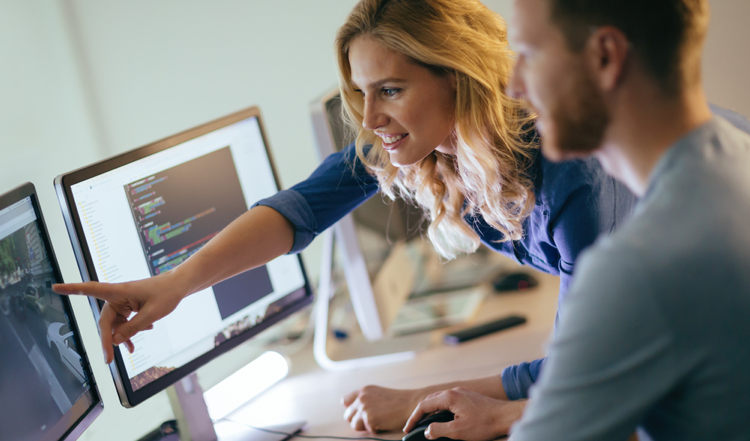 Two-IT-professionals-working-together-in-front-of-computers