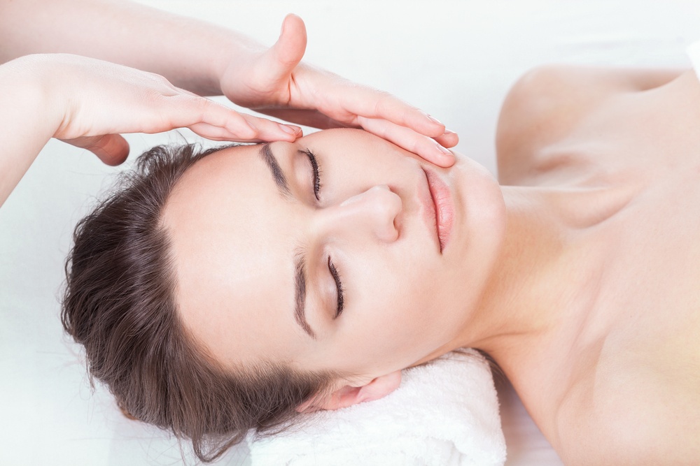 Lady during face massage in spa, horizontal