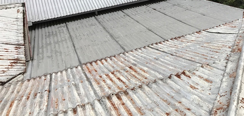 Rusted and flaking roof sheets on old roof